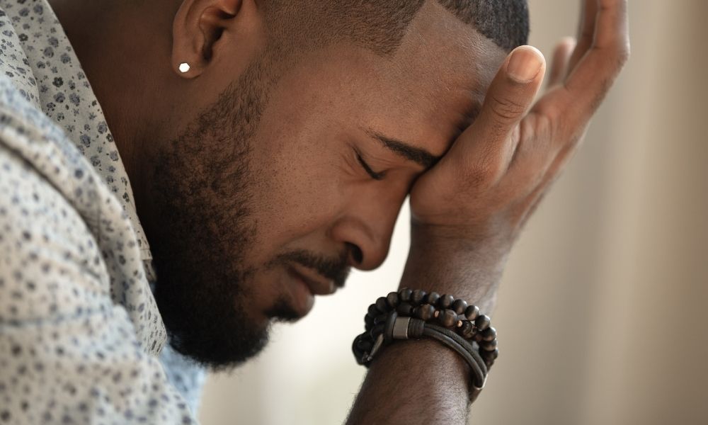 African American Male enduring a tension headache