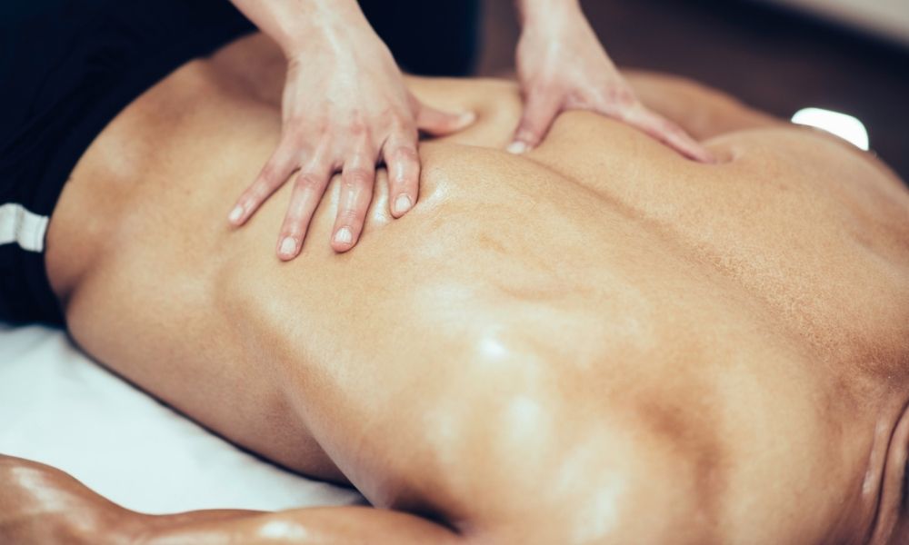 Male massage client receiving regularly scheduled massage