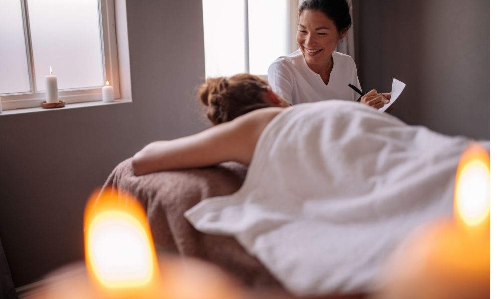 Female massage client communicating with therapist regarding her massage preferences